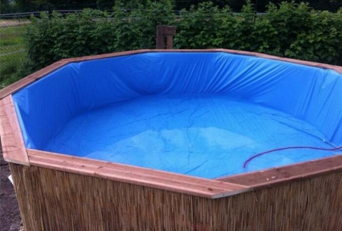 Entuziastas pastatytas baseinas ant vasaros rezidencija įprastų medinių padėklų nuo dizaino iš interneto